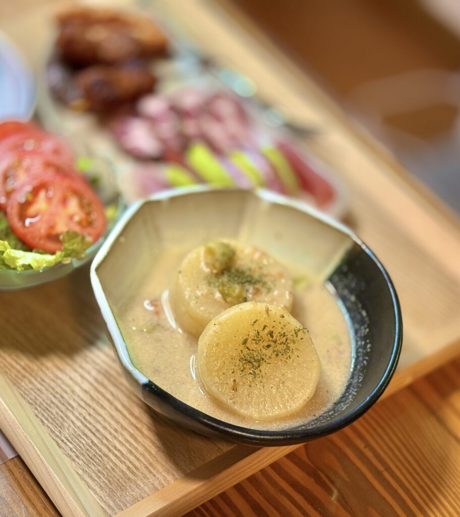 コンソメで煮た大根にきのこクリームソースをかけた洋風大根煮。ハーブを散らした優しい味わいの一皿。