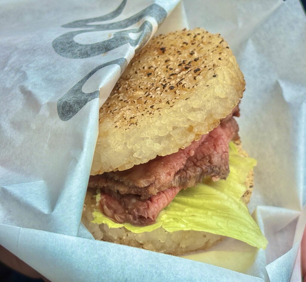 ボリューム満点!特製タレと柔らかい松阪牛ローストビーフの層が食欲をそそる、おかげ横丁名物の松阪牛ライスバーガー