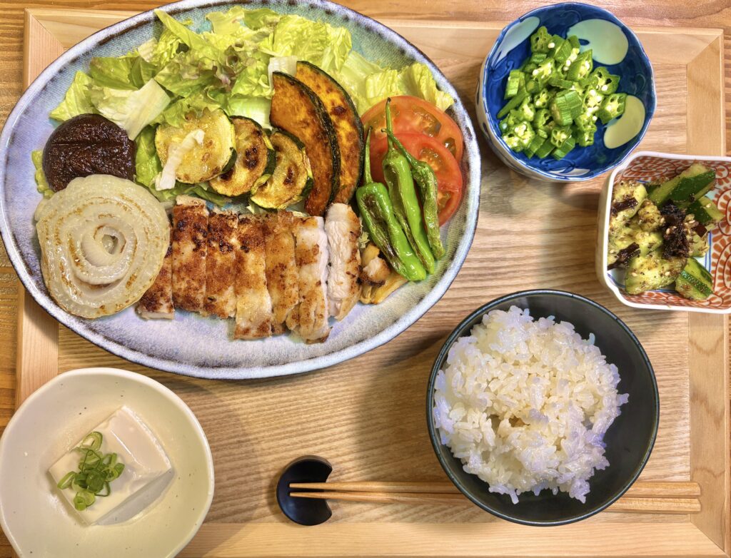 生塩糀パウダーで漬けたトンテキ定食の全体。ご飯・冷奴・刻みおくら・叩ききゅうりのおかか昆布和えが並ぶ旦那キッチンの食卓