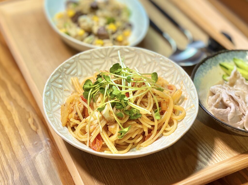 残ったブイヤベースの旨みを活かしたトマトパスタ。魚介のだしとトマトの酸味をパスタに絡め、かいわれをのせたリメイクおうちごはん