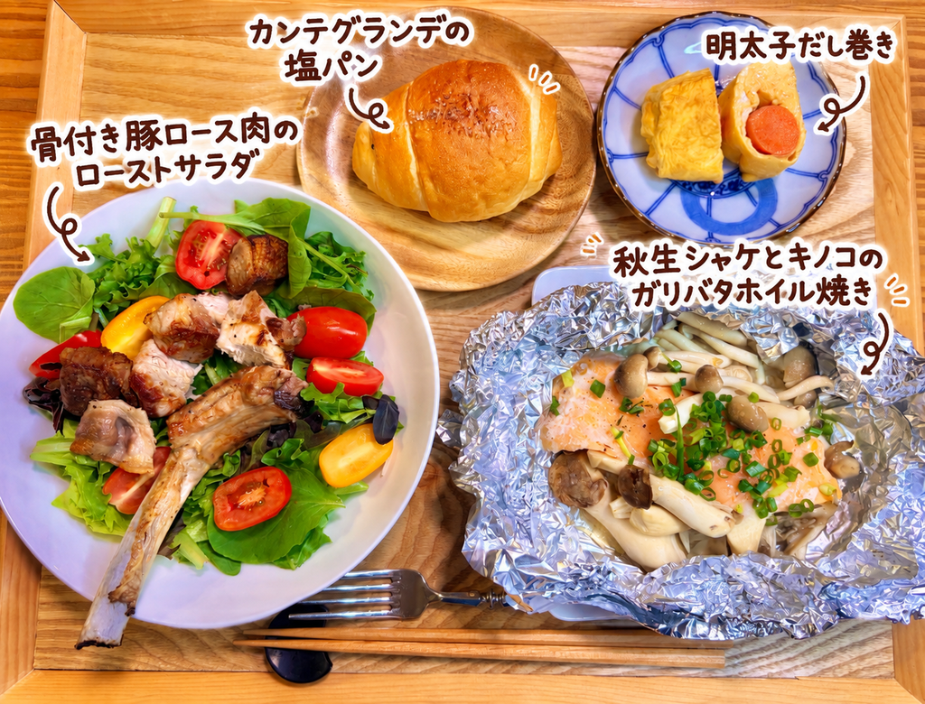 骨付き豚ロース肉のローストサラダ、秋生鮭ときのこのガリバタホイル焼き、明太子だし巻き、カンテグランデの塩パンを盛り付けた秋の晩ごはん献立